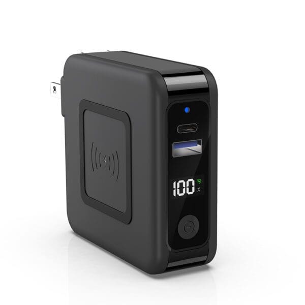 Portable black battery charger with usb port and digital display showing 100% charge, isolated on white background.