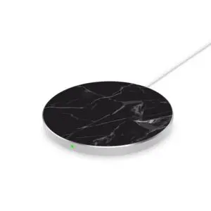 A black and white marble-patterned wireless charging pad with a green indicator light and a white cable.