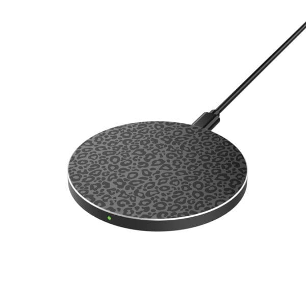 A wireless charging pad with a black and gray leopard print design, connected to a cable, shown on a white background.