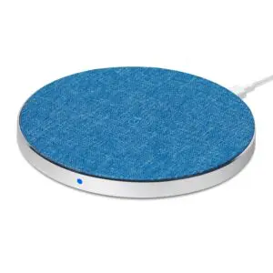 A round, fabric-covered wireless charging pad with a white rim and an led indicator light, photographed on a white background.