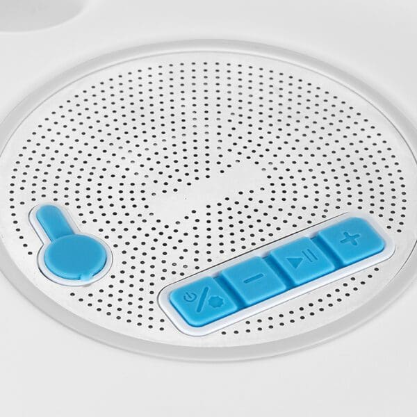 Close-up of a white circular speaker with blue control buttons for volume and playback.