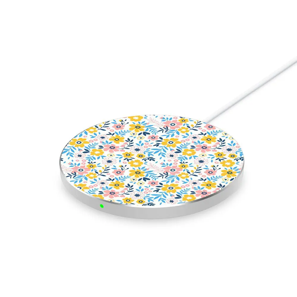 Round wireless charging pad with a floral pattern on a white background.