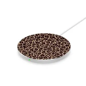 A wireless charging disc with a leopard print design on the top surface and a visible white cable attached, showing a small green indicator light.
