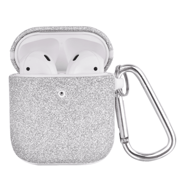 Wireless earbuds in a glittery silver case with a keychain attached, isolated on a green background.