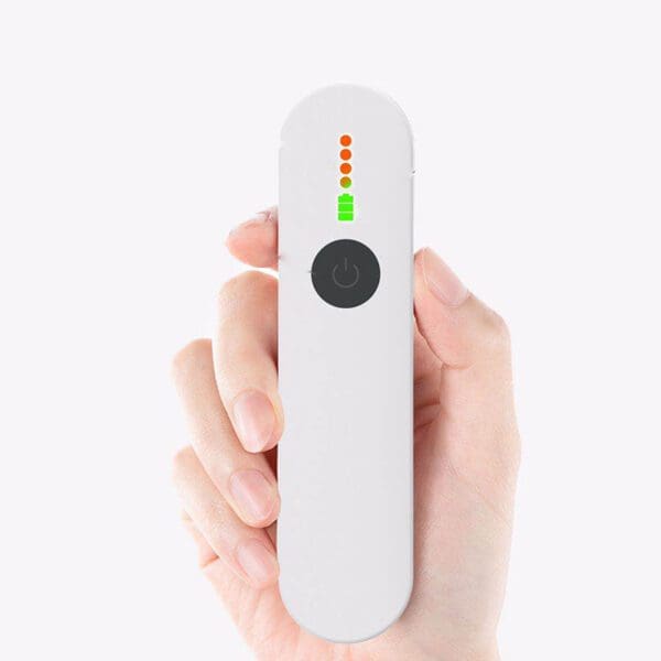 Hand holding a sleek, white remote control with a power button and multicolored led indicator lights on a plain background.
