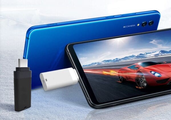 Blue smartphone with a racing car on the screen, lying next to a white usb flash drive, set against an icy background.