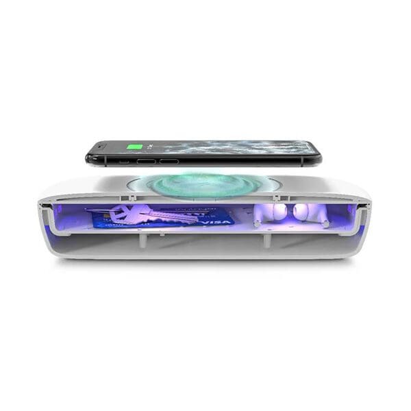 Smartphone lying on a uv light sanitizer device, shown with a transparent view of internal components.