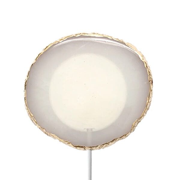 White circular lampshade with a gold trim on a simple stand, against a plain white background.