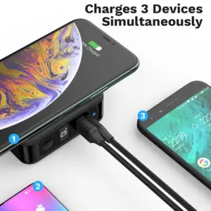 Portable charger connected to three smartphones, displaying a text overlay "charges 3 devices simultaneously.