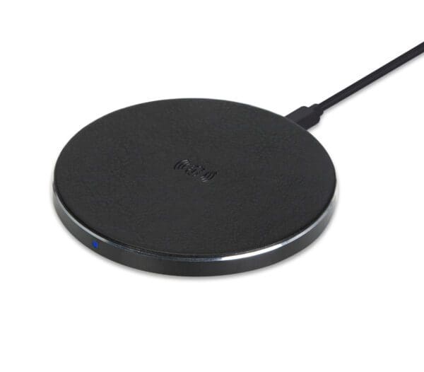 A black wireless charging pad with a usb cable connected, on a white background, showing a small blue power indicator light on the edge.
