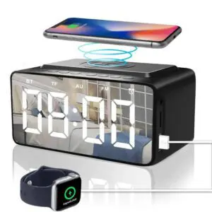 Digital clock with wireless charging capability displayed alongside a charging smartphone and smartwatch.