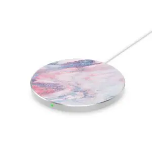 A wireless charging pad with a marble pattern and a white cable, isolated on a white background.