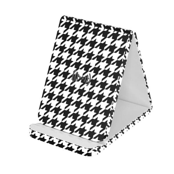 A black and white phone stand with a houndstooth pattern.