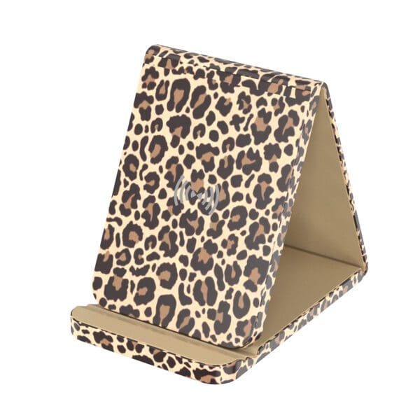 A leopard print phone holder sitting on top of a table.