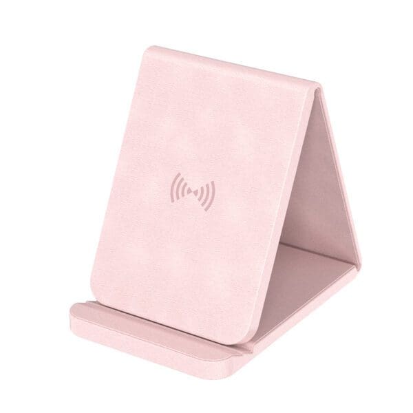 A pink phone holder sitting on top of a table.