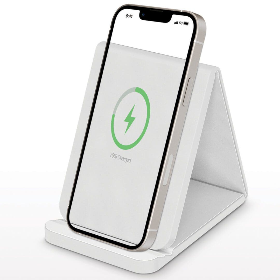 A white phone sitting on top of a stand.
