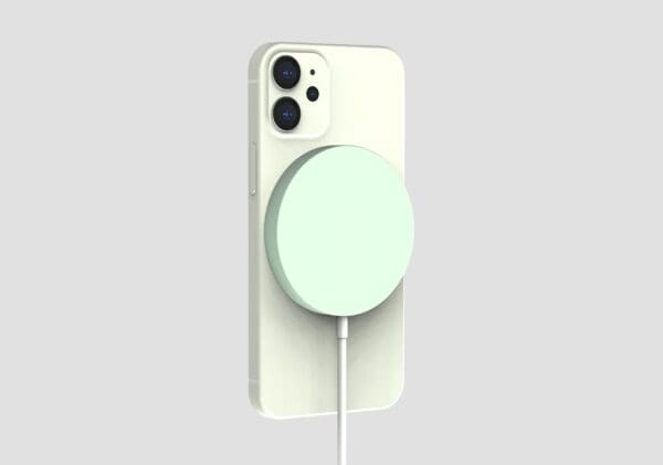 A white smartphone with a triple-camera system connected to a mint-colored magnetic wireless charger against a gray background.