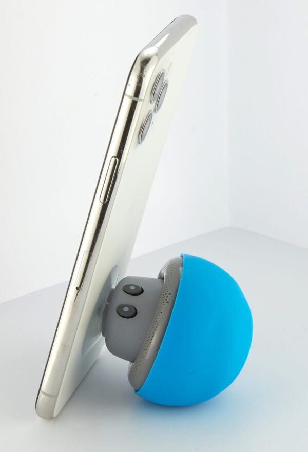 A smartphone leaning on a blue, spherical device with buttons, against a white background.