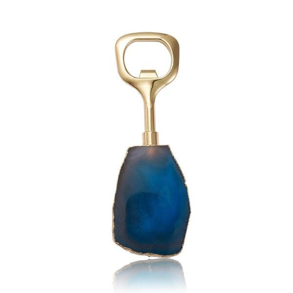 Gold bottle opener with a blue agate stone handle, isolated on a white background.
