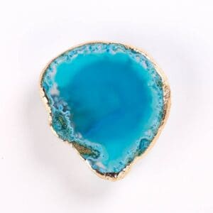 Turquoise agate slice with a naturally textured rim on a plain white background.