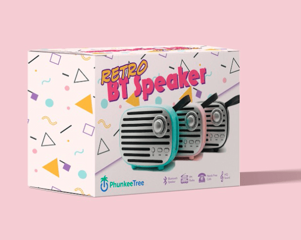 Boxed "retro bitspeaker" with a colorful, vintage microphone design, displayed against a pink background with geometric shapes.
