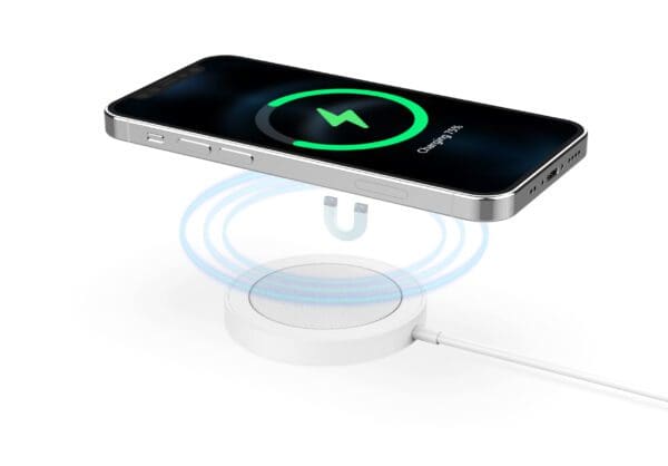 A smartphone charging on a white wireless charging pad, displaying a green charging icon on its screen.