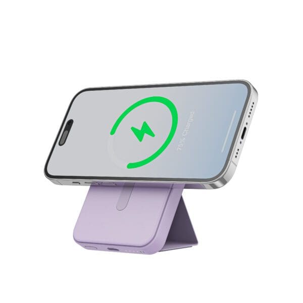 Smartphone on a purple stand showing a green charging symbol on its screen indicating 75% charged.