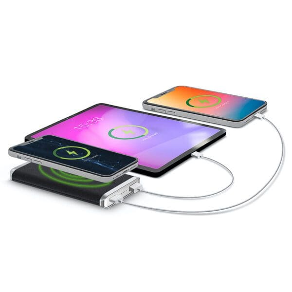 Three smartphones and a tablet charging simultaneously on a Leather Wireless Charging Power Bank, displayed against a white background.