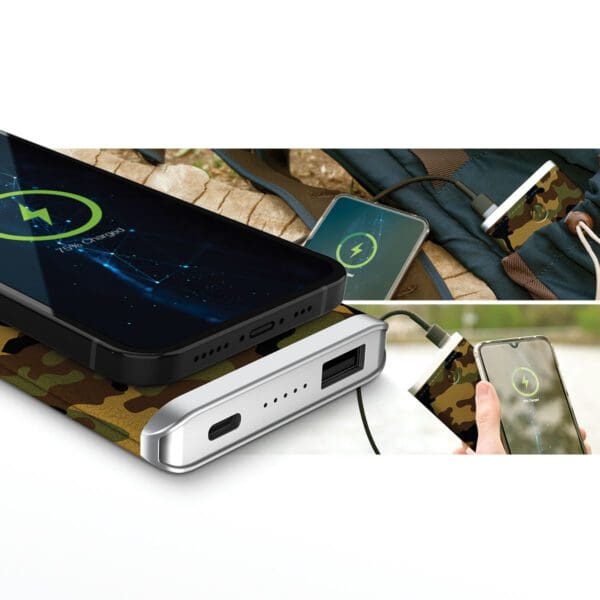 Portable Grey - Leather 5K Wireless Charging Power Bank charging two smartphones, one wirelessly and one via cable, placed on a desk next to a backpack.