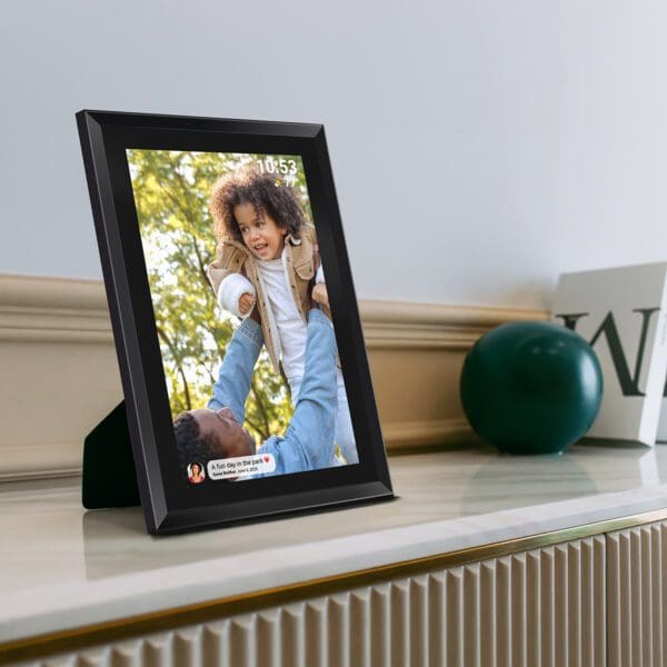Product Sentence: Digital Picture & Video Frame displaying a joyful father lifting his daughter in the air, set on a home shelf.