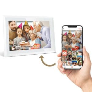 A Digital Picture & Video Frame displays an image of a multi-generational family celebrating a birthday, while a person views the same image on a smartphone app.