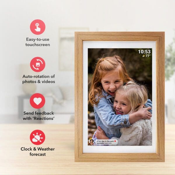 A Digital Picture & Video Frame displaying a photo of two young children embracing, with icons indicating touchscreen, auto-rotation, reactions, and clock/weather features.