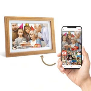 A hand holding a smartphone displaying an app interface for syncing photos next to a **Digital Picture & Video Frame** showing a family celebrating an elderly woman's birthday.