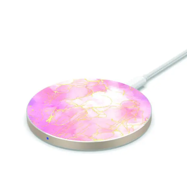 A round, pink and gold Wireless Charging Marble Pad with a connected white cable on a white background.