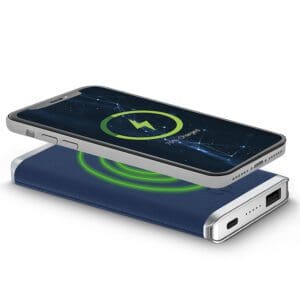 A smartphone resting on a Houndsooth - Leather 5K Wireless Charging Power Bank, displaying a charging icon on its screen, with a glowing green spiral indicating power transfer.