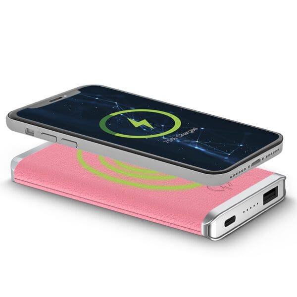 Leather Wireless Charging Power Bank lying on a pink leather charging pad with a lightning bolt icon on the screen, indicating it is charging.