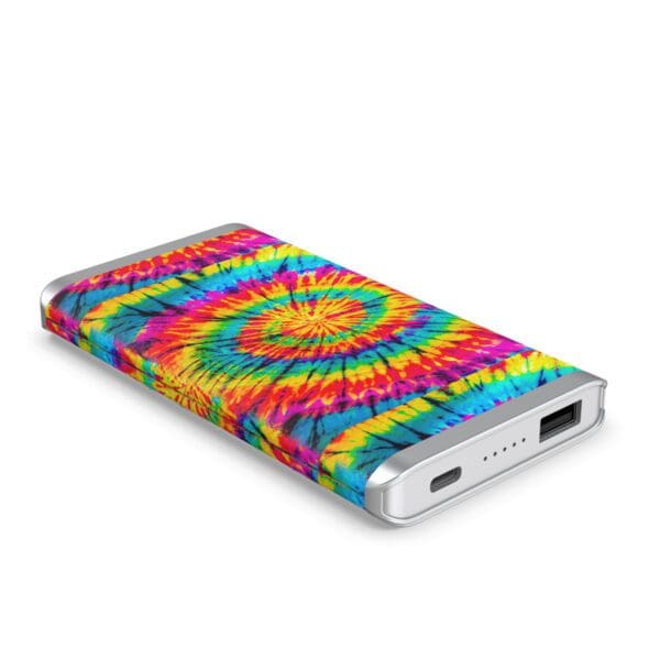 A Grey Leather 5K Wireless Charging Power Bank with a vibrant tie-dye design featuring a spectrum of colors and a central swirl pattern, isolated on a white background.