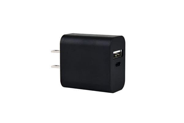 Black USB wall charger with prongs.